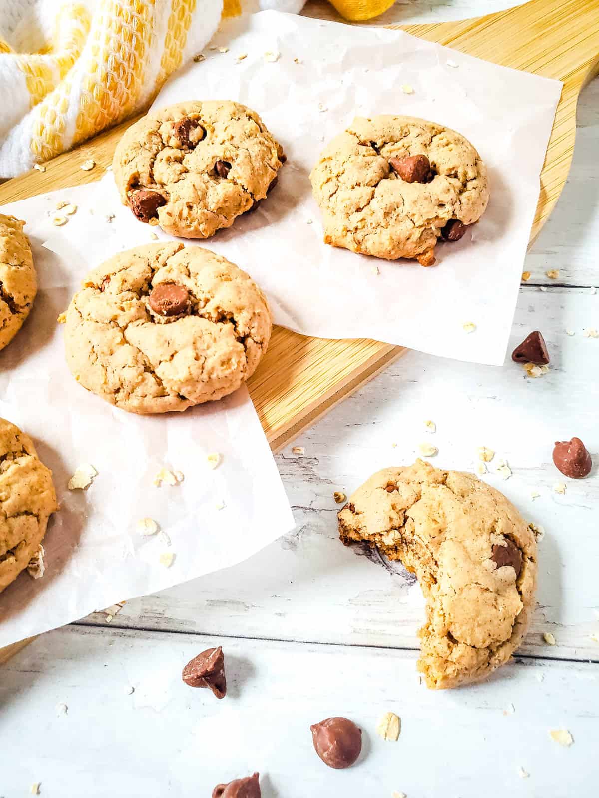 Oatmeal cookies with chocolate chips made with cake mix on a table and one has a big bite out of it.