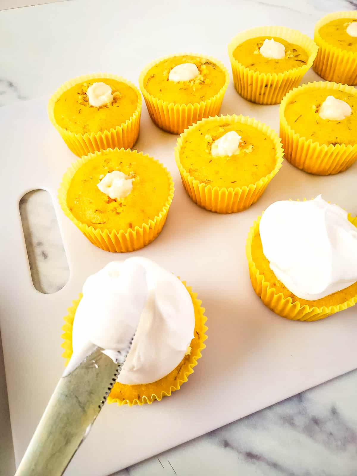 Frosting the banana pudding cupcakes.