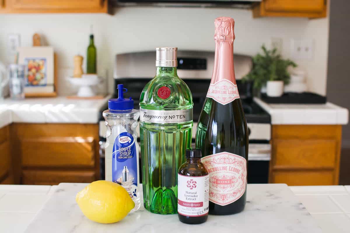 The ingredients for a Lavender French 75 cocktail on the countertop.