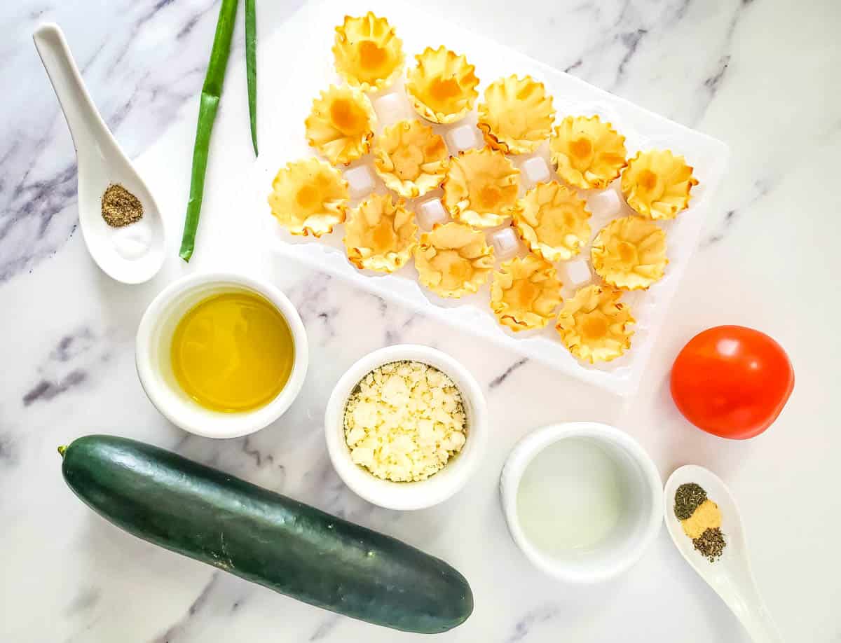 Ingredients to make phyllo cup appetizers with tomato and cucumber.