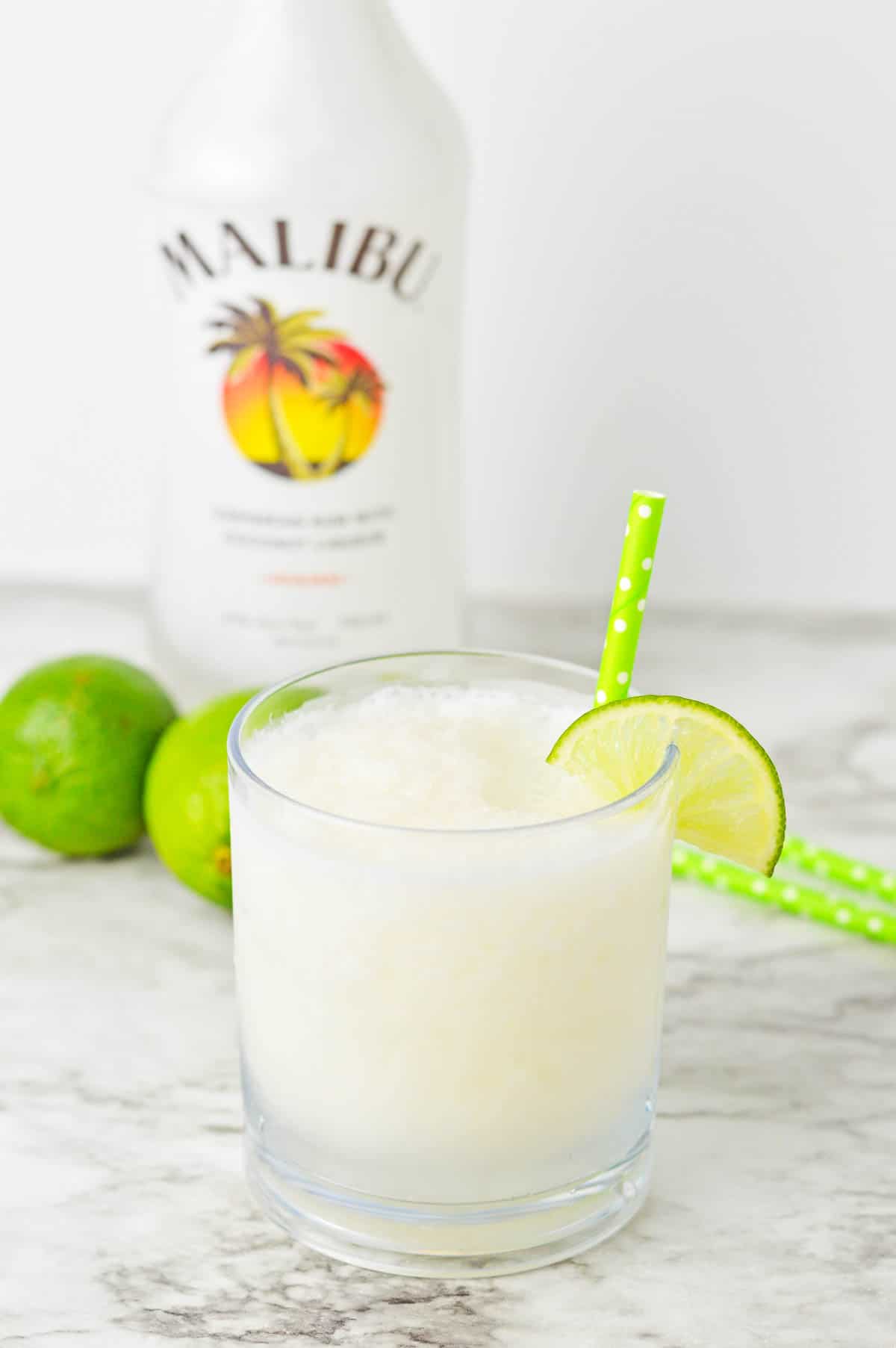 Frozen coconut daiquiri with a bottle of Malibu in the background.