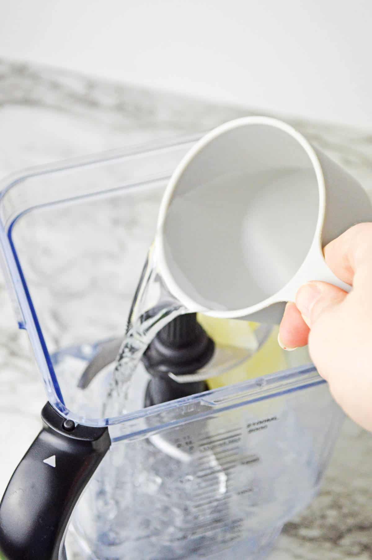 Rum being poured into a blender.