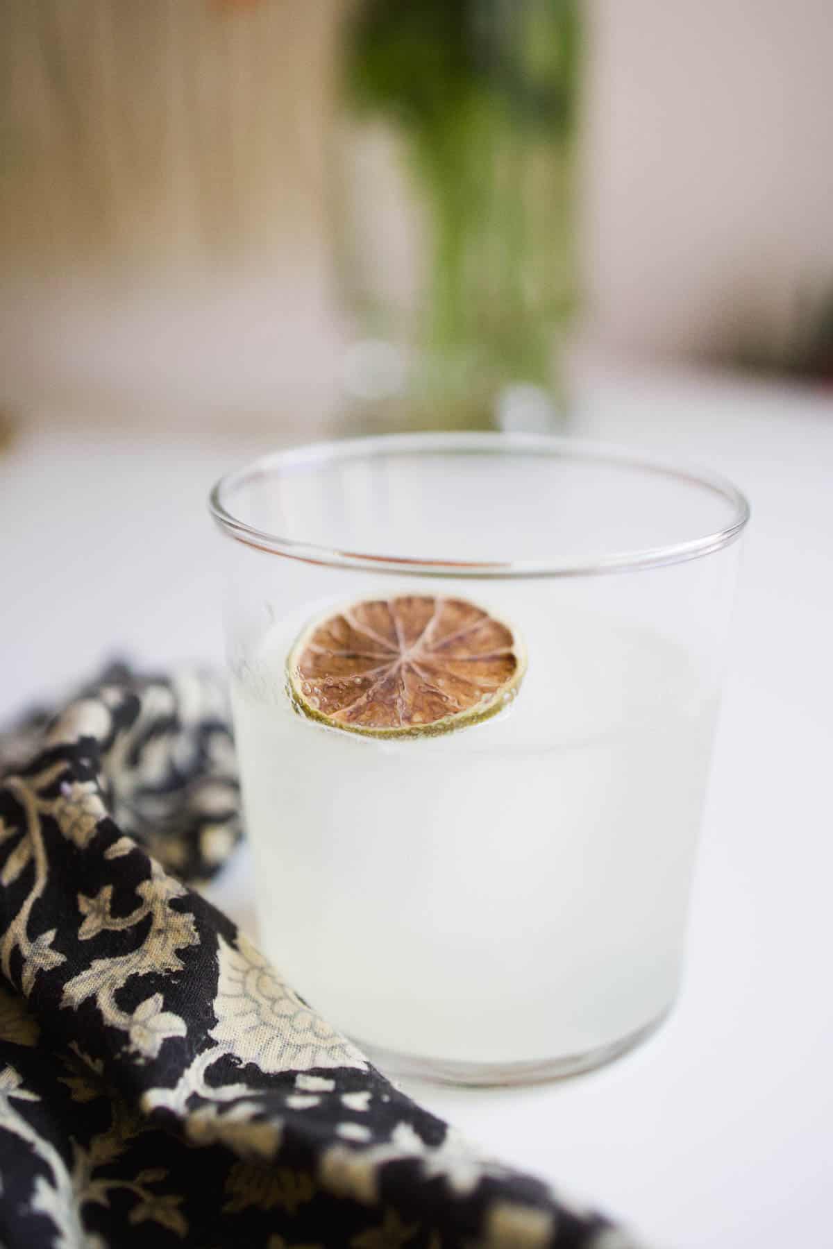 A St Germain Gin Cocktail in a tumbler on a countertop.