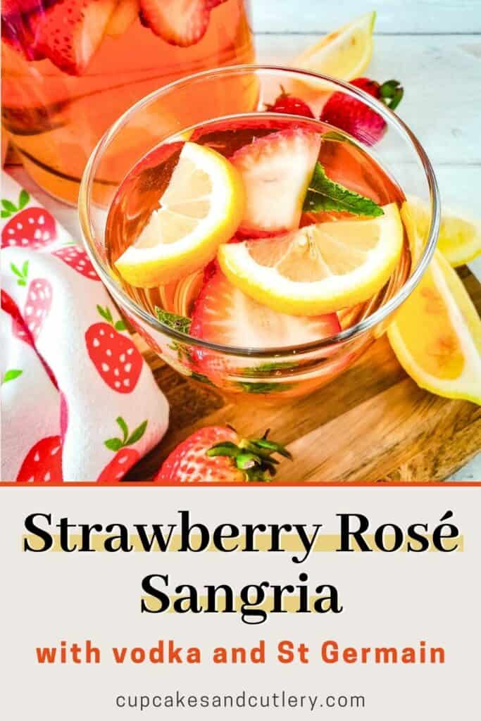 Tumbler of Strawberry Sangria with lemon slices.