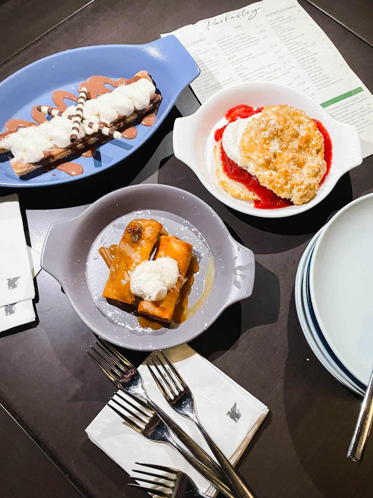 3 plated desserts on a table at Parkestry Rooftop bar in the JW Marriott in Anaheim.