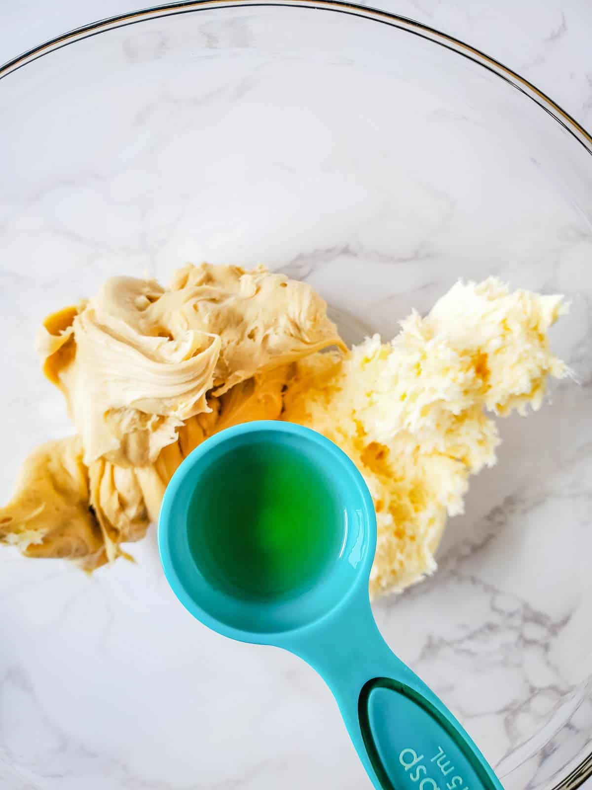 Combining Hennessy cognac into the salted caramel and buttercream frosting.