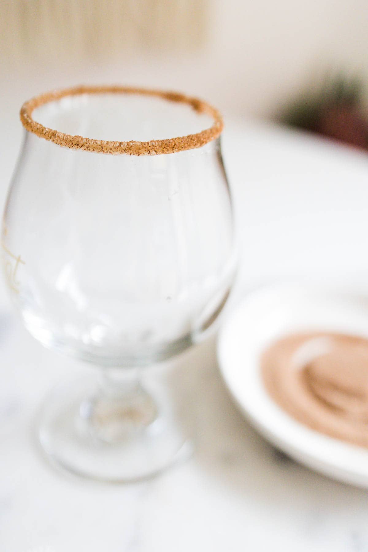 Empty glass with a cinnamon sugar rim.