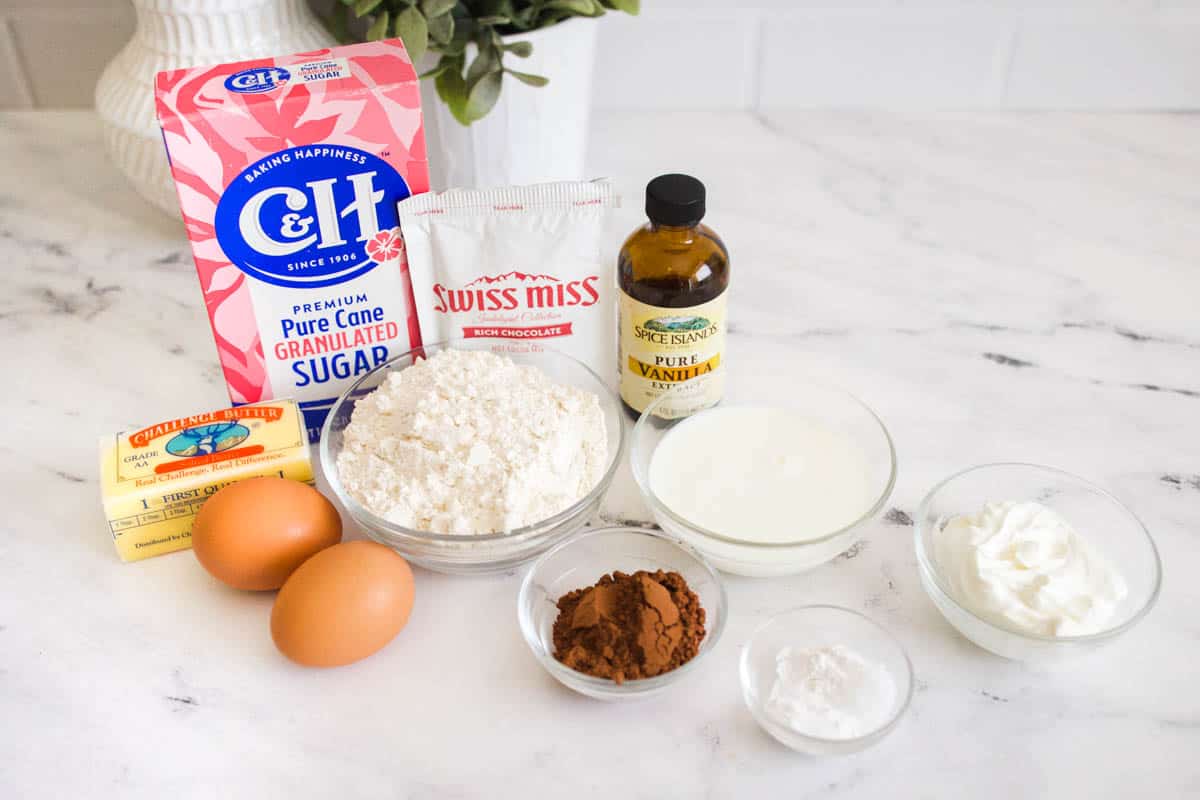 Ingredients to make hot chocolate cupcakes from scratch on a table. 