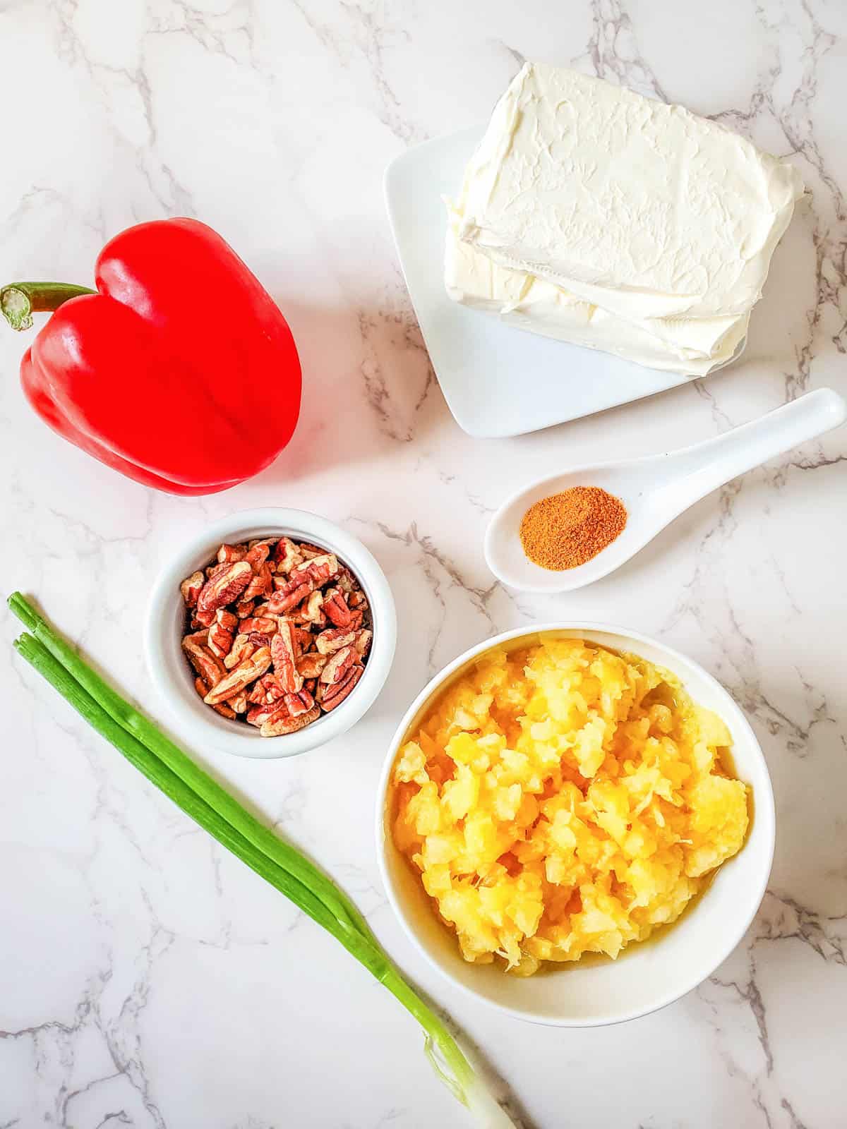 Ingredients needed to make cheese ball with pineapple on a counter.