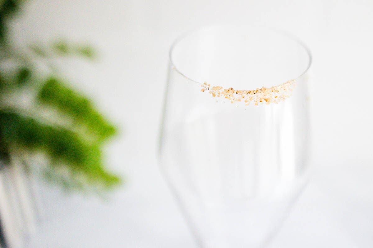 Close up of a cinnamon sugar rim on a champagne flute.