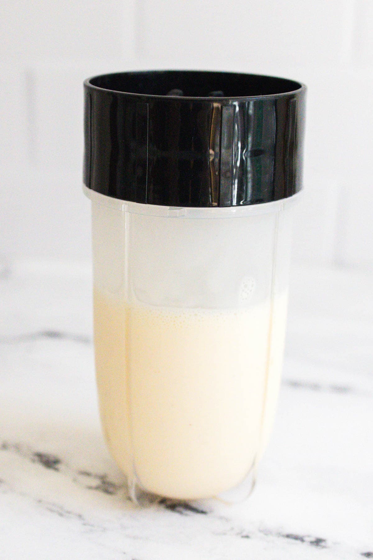 A creamy cocktail inside a blender cup.